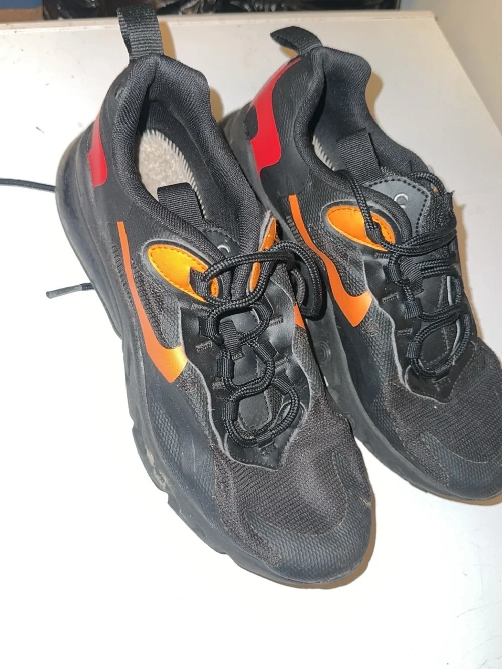 Nike Kids Black Sneakers with Orange and Red Accents